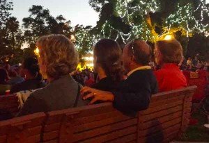 Audience members enjoyed themselves. We are assuming he has his hand on his wife