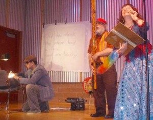 Just Kibbe (kneeling) with Kathabela and Rick Wilson at Boston Court in the Figures of Humor and Strange Beauty production directed and hosted by Just.