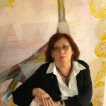 Susan Dobay in front of one of her paintings.