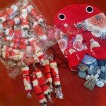 Japanese Santa Crackers (left) , with "lucky Jizo" painted by Kris Kondo, Japan, representing the joining of hearts, those gone and here (Photo - Kathabela Wilson).