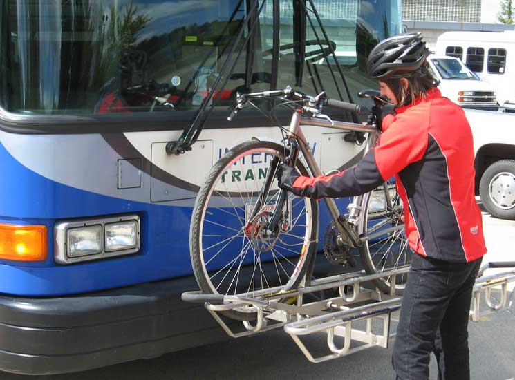 Kerry placing bike on bus bike rack (Photo - Inter City Transit).