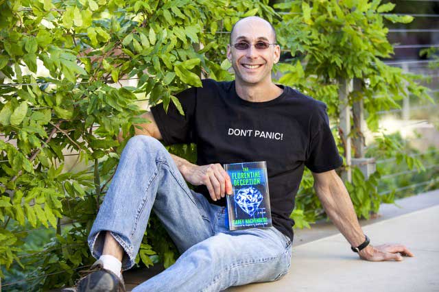 Carey Nachenberg holds a copy of his first novel, “The Florentine Deception." All sales proceeds will be donated to charities focused on youth development and education (Photo - Hannah Ye).