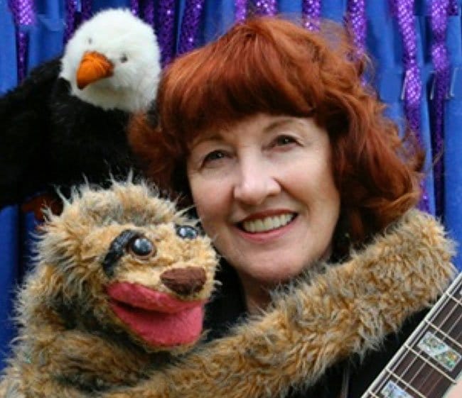 Penelope Torribio with the sloth puppet she made for a rain forest musical (Photo - 1worldmusicandpuppets.com).